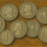 Silver US quarters are lying on the table.